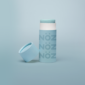 Noz Sunscreen in blue, with the cap off showing the stick of colorful sunscreen inside